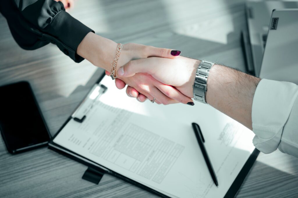 pexels photo 17682883 17682883 Close-up of a professional handshake over a contract, symbolizing a successful business deal.